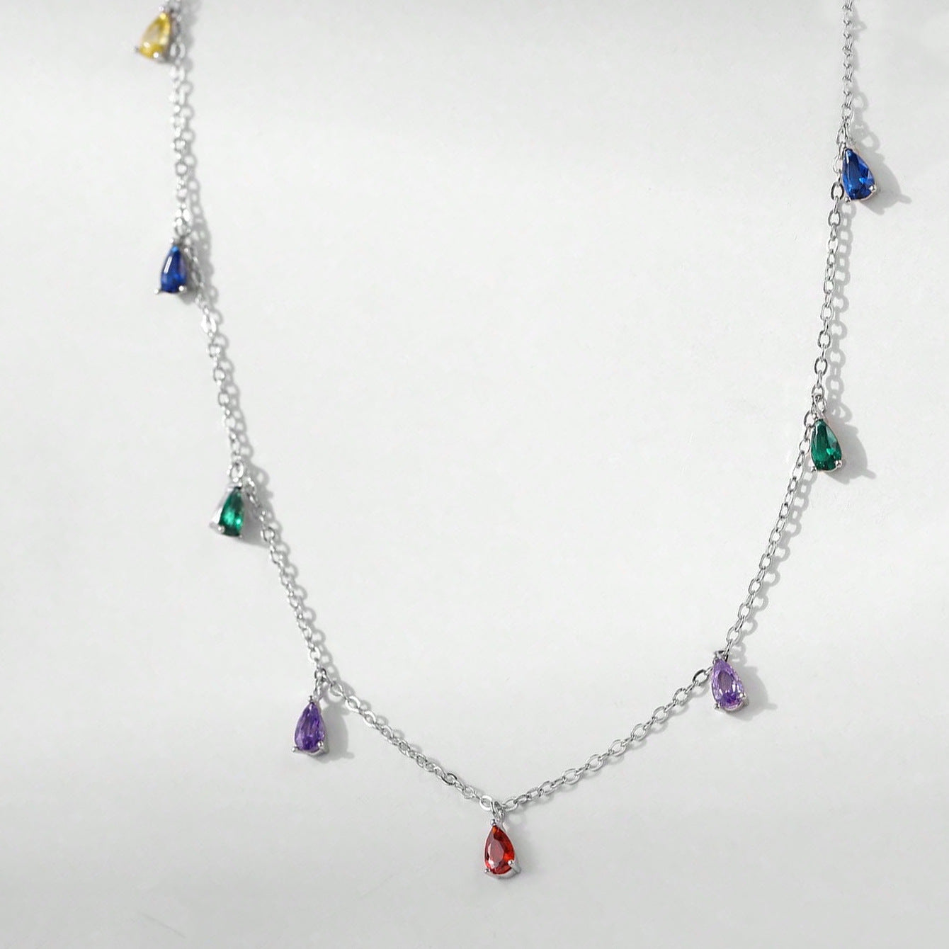 A Minimalist 925 Silver Necklace Featuring A Pendant With 9 Colorful Teardrop shaped Pendants