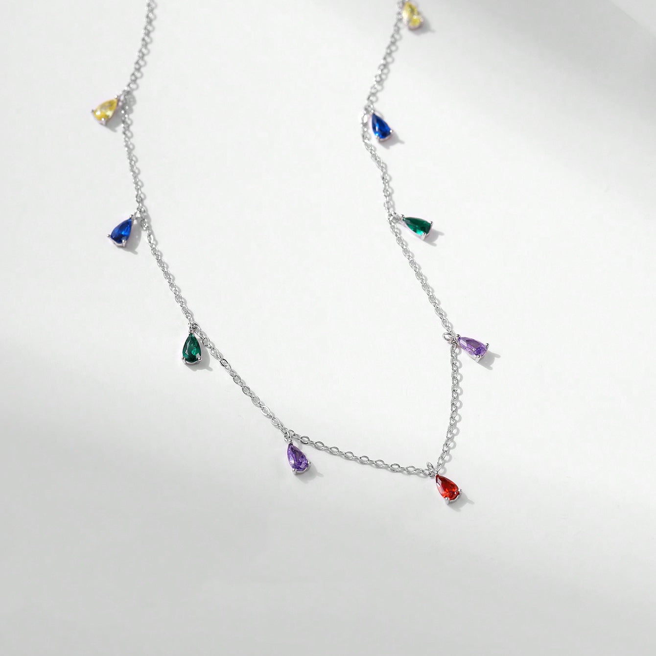 A Minimalist 925 Silver Necklace Featuring A Pendant With 9 Colorful Teardrop shaped Pendants