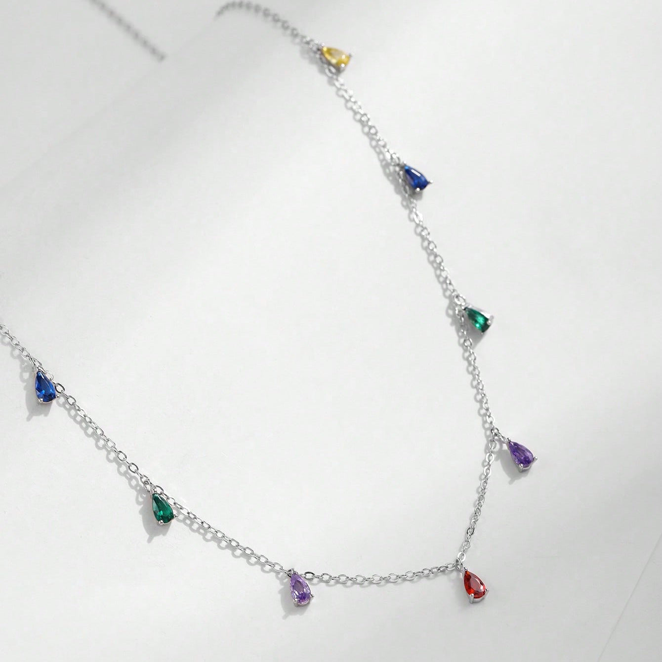 A Minimalist 925 Silver Necklace Featuring A Pendant With 9 Colorful Teardrop shaped Pendants